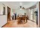 Open dining room featuring hardwood floors, a ceiling fan, and sliding glass doors to the backyard at 6458 W Clifton Pl, Littleton, CO 80128
