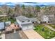 Two-story home featuring a two-car garage, well-maintained landscaping, and mountain views at 6458 W Clifton Pl, Littleton, CO 80128