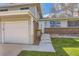 Charming home exterior with a brick facade, garage, and well-manicured lawn at 6458 W Clifton Pl, Littleton, CO 80128