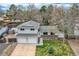 Charming home with a manicured front lawn, mature trees, and a two-car garage at 6458 W Clifton Pl, Littleton, CO 80128