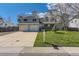 Charming two-story home with a well-manicured lawn, mature trees, and an attached two-car garage at 6458 W Clifton Pl, Littleton, CO 80128