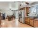 Open-concept kitchen and dining area with stainless steel appliances and natural light at 6458 W Clifton Pl, Littleton, CO 80128