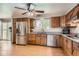 Traditional kitchen featuring wood cabinets, stainless steel appliances, granite countertops, and natural light at 6458 W Clifton Pl, Littleton, CO 80128
