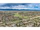Expansive view of a neighborhood with mature trees, green spaces, and mountain views at 6458 W Clifton Pl, Littleton, CO 80128