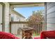 Cozy balcony with stone fire pit, two red chairs, and a view of greenery and neighboring buildings at 3252 E 103Rd Dr # 708, Denver, CO 80229