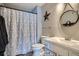 Bathroom showcasing a vanity, toilet, shower with decorative curtain and wood-look vinyl flooring at 3252 E 103Rd Dr # 708, Denver, CO 80229