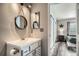 Bathroom featuring a vanity, decorative lighting and mirrors, with wood-look vinyl flooring at 3252 E 103Rd Dr # 708, Denver, CO 80229