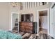 Primary bedroom showcasing a TV atop a dresser, decorative lighting and wood-look vinyl flooring at 3252 E 103Rd Dr # 708, Denver, CO 80229