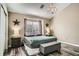 Cozy bedroom showcasing stylish décor, a large window, and attractive wood-look vinyl flooring at 3252 E 103Rd Dr # 708, Denver, CO 80229