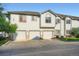 Exterior of a light-colored townhome showcasing a triple car garage and an inviting architectural design at 3252 E 103Rd Dr # 708, Denver, CO 80229