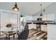 Bright eat-in kitchen with stainless steel appliances, granite countertops, and wood-look vinyl flooring at 3252 E 103Rd Dr # 708, Denver, CO 80229