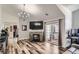 Bright living room featuring a stone fireplace, glass doors to patio, and an elegant chandelier at 3252 E 103Rd Dr # 708, Denver, CO 80229