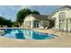 Relaxing community pool area with sparkling blue water, surrounded by lounge chairs and lush greenery on a sunny day at 3252 E 103Rd Dr # 708, Denver, CO 80229