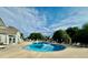 Community pool on a clear day with inviting blue water, sun loungers, and picturesque landscaping at 3252 E 103Rd Dr # 708, Denver, CO 80229