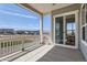 Balcony with white railing showcasing a view of the neighborhood and sliding door to dining area at 423 Basin Daisy St, Castle Rock, CO 80104