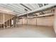 Unfinished basement featuring concrete floors and walls covered in white plastic in a new home at 423 Basin Daisy St, Castle Rock, CO 80104