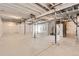 Unfinished basement with concrete floor, exposed ceiling beams and plastic covered walls ready to be finished at 423 Basin Daisy St, Castle Rock, CO 80104