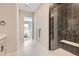 Modern bathroom features an upgraded glass shower, double vanity, and modern tile at 423 Basin Daisy St, Castle Rock, CO 80104
