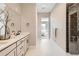 Modern bathroom features an upgraded glass shower, double vanity, and modern tile at 423 Basin Daisy St, Castle Rock, CO 80104