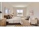 Bright bedroom features a checkered rug, lots of natural light, and neutral decor at 423 Basin Daisy St, Castle Rock, CO 80104