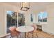 Bright breakfast nook with a marble table, pink chairs, natural light, and built in desk next to backyard door at 8898 Chestnut Hill Ct, Highlands Ranch, CO 80130