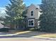 Charming two-story home with brick accents, large trees, and a well-maintained lawn on a sunny day at 8898 Chestnut Hill Ct, Highlands Ranch, CO 80130