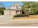 Inviting two-story home with a two-car garage, brick accents, and lush landscaping on a clear day at 8898 Chestnut Hill Ct, Highlands Ranch, CO 80130