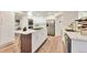 Modern kitchen with white cabinetry, stainless steel appliances, island with seating, and ample counter space at 8898 Chestnut Hill Ct, Highlands Ranch, CO 80130