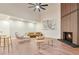 Bright living room with wood floors, fireplace, high ceilings, fan, modern seating, and a neutral color scheme at 8898 Chestnut Hill Ct, Highlands Ranch, CO 80130