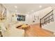 Bright living room with wood floors, a curved sofa, and a modern staircase with black railings at 8898 Chestnut Hill Ct, Highlands Ranch, CO 80130