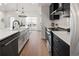 Modern kitchen with black cabinets, white countertops, and stainless steel appliances at 4539 Tabor St, Wheat Ridge, CO 80033