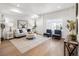 Cozy living room with hardwood floors, neutral decor, and ample natural light from large windows at 4539 Tabor St, Wheat Ridge, CO 80033