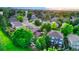 Picturesque aerial view showcasing a residential neighborhood with lush green trees and well-maintained homes at 5150 Morning Glory Pl, Highlands Ranch, CO 80130
