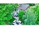 Aerial view of backyard oasis including a patio with seating, trees, hot tub, and second story deck at 5150 Morning Glory Pl, Highlands Ranch, CO 80130