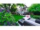 Beautiful backyard with hot tub, outdoor seating, lush green lawn and professional landscaping at 5150 Morning Glory Pl, Highlands Ranch, CO 80130