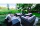 Inviting backyard with stone tile patio and sleek outdoor seating to enjoy the scenery at 5150 Morning Glory Pl, Highlands Ranch, CO 80130