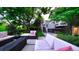 Relaxing backyard features a hot tub, lounge area, mature trees, and lush landscaping at 5150 Morning Glory Pl, Highlands Ranch, CO 80130