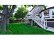 Expansive backyard featuring a spacious deck, large lawn, and privacy fence at 5150 Morning Glory Pl, Highlands Ranch, CO 80130