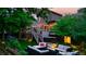 Picturesque backyard with hot tub, outdoor seating area, and illuminated by string lights at 5150 Morning Glory Pl, Highlands Ranch, CO 80130