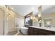 Beautiful bathroom featuring a soaking tub, glass shower, double vanity, and modern finishes at 5150 Morning Glory Pl, Highlands Ranch, CO 80130