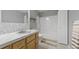 Bathroom features a marble tiled backsplash, a shower with a glass door, and a wood vanity with drawers at 5150 Morning Glory Pl, Highlands Ranch, CO 80130
