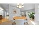 Elegant dining area with modern furnishings, a stylish chandelier, and an open layout to the living space at 5150 Morning Glory Pl, Highlands Ranch, CO 80130