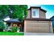 Charming two-story home featuring well-maintained front lawn, brick accents, and a spacious two-car garage at 5150 Morning Glory Pl, Highlands Ranch, CO 80130
