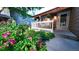 Landscaped front yard featuring vibrant flowers, manicured greenery, and a charming walkway leading to the front door at 5150 Morning Glory Pl, Highlands Ranch, CO 80130