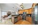Modern kitchen with wood cabinets, stainless steel appliances, and an open design connecting to the living area at 5150 Morning Glory Pl, Highlands Ranch, CO 80130
