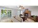 Comfortable living room with fireplace, neutral tones, and a sliding door leading to outdoor deck at 5150 Morning Glory Pl, Highlands Ranch, CO 80130
