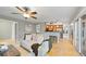 Cozy living room featuring hardwood floors, neutral decor, and seamless flow to the modern kitchen at 5150 Morning Glory Pl, Highlands Ranch, CO 80130