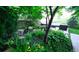 Backyard pond surrounded by lush green foliage, rocks, and yellow wildflowers creates a relaxing atmosphere at 5150 Morning Glory Pl, Highlands Ranch, CO 80130