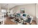 Bright living room featuring modern decor, hardwood floors, and an open layout connecting to the adjacent kitchen area at 18835 E Utah Cir, Aurora, CO 80017