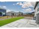 Spacious backyard featuring artificial turf, concrete patio, gravel landscaping, and a wooden fence at 2159 Indian Balsam Dr, Monument, CO 80132